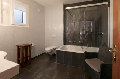 a bathroom with a tub and a toilet and a sink at Hotel Hecht in Appenzell