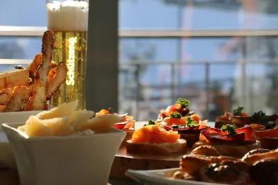 a table topped with plates of food next to a window at Hotel & Spezialitätenrestaurant zur Linde in Teufen