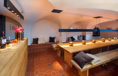 a barbershop with a long table in a room at Hotel Hirschen Wildhaus in Wildhaus