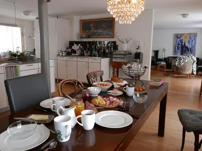 a table with plates of food on it in a kitchen at BnB chezlise in Urnäsch