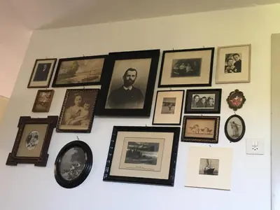 a wall full of pictures on a wall at BnB chezlise in Urnäsch