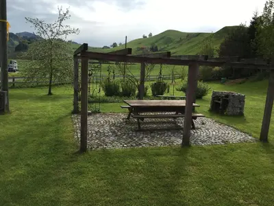 a picnic table and a bench in the grass at BnB chezlise in Urnäsch
