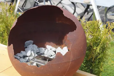 a metal bowl with rocks in it on a table at Bodenseehotel Weisses Rössli in Staad
