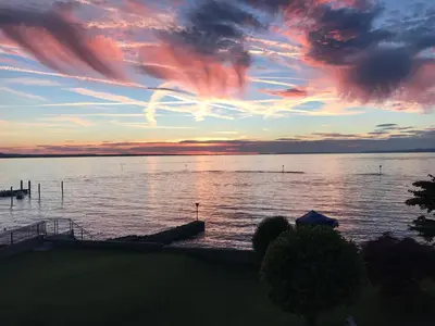 a sunset over a large body of water at Bodenseehotel Weisses Rössli in Staad