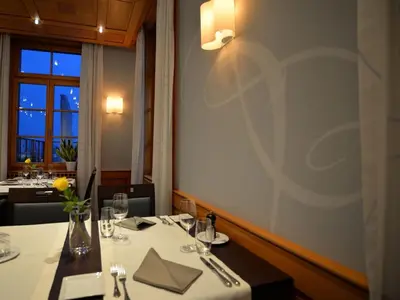 a table in a restaurant with a white table cloth at Hotel Brauerei Frohsinn in Arbon