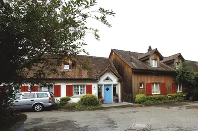 a house with a car parked in front of it at Hotel Garni Sonne in Landschlacht Gemeinde Münsterlingen