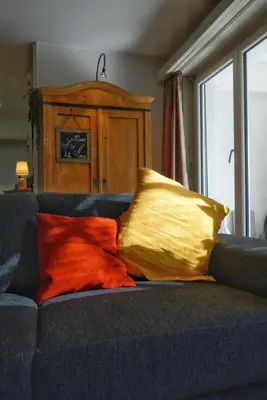 a blue couch with two pillows on it at Lakelodge Romanshorn in Romanshorn