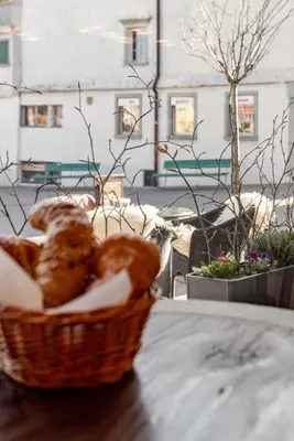 a basket of bread sitting on top of a table at Hotel Appenzell in Appenzell
