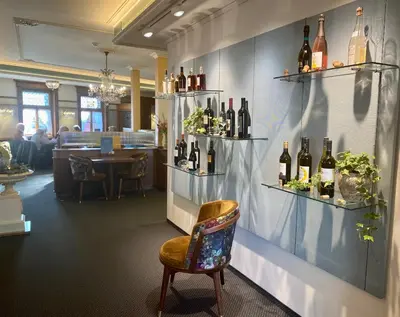 a room with shelves of wine bottles on the wall at Hotel Appenzell in Appenzell