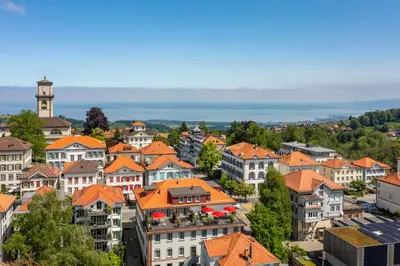an aerial view of a town with orange roofs at Linde Heiden Swiss Quality Hotel in Heiden