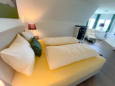 a living room with a couch with pillows at Trompeterschlössle Hotel & Residence in Tägerwilen