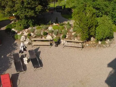 an overhead view of a garden with benches and rocks at Hotel Restaurant Belvedere in Weissbad
