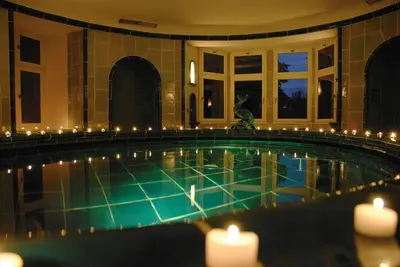 a swimming pool with candles in a building at Schloss Wartegg in Rorschacherberg