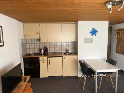 a kitchen with a table and a table and chairs at Ferienwohnung Inauen in Appenzell