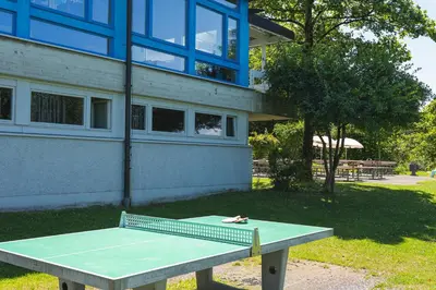a picnic table in front of a building at St. Gallen Youth Hostel in St. Gallen