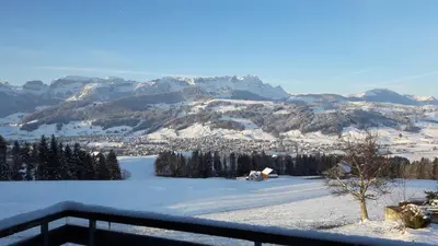 a view of a snow covered mountain with a town at Ferienstudio Familie Fässler-Dörig in Appenzell