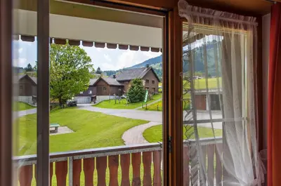 a window with a view of a yard at Schwendi Lodge in Unterwasser