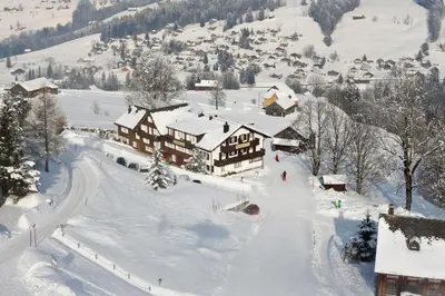 an aerial view of a ski lodge in the snow at Schwendi Lodge in Unterwasser