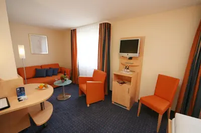 a hotel room with a couch and a table at Hotel Buchserhof in Buchs