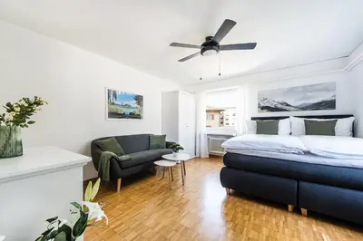 a bedroom with a bed and a living room at SOHO 2A !Gratis Parken, Free Parking! in Kreuzlingen