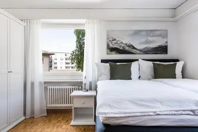 a bedroom with a white bed and a window at SOHO 2A !Gratis Parken, Free Parking! in Kreuzlingen