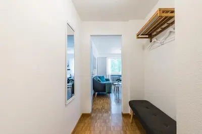 a hallway with a black bench in a room at SOHO 2A !Gratis Parken, Free Parking! in Kreuzlingen