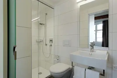 a bathroom with a toilet and a sink and a shower at Gasthof Eisenbahn in Weinfelden