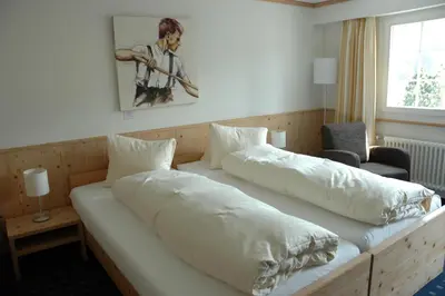 a bedroom with two beds with white sheets at Landgasthof Sternen in Bühler