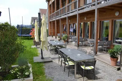a row of tables and chairs outside of a building at Gasthaus Löwen in Hemberg