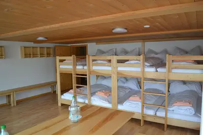 a room with three bunk beds in a room at Gasthaus Löwen in Hemberg