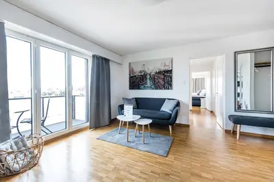 a living room with a couch and a table at SOHO 8 !Lake-Mountain View & Free Parking! in Kreuzlingen