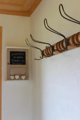 a light hanging from a wall with a sign at Chalet Nueschwendi in Ebnat