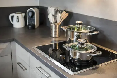 two pots and pans on a stove in a kitchen at Bella Vista in Wildhaus