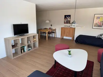 a living room with a tv and a table at Jizerka in Unterwasser