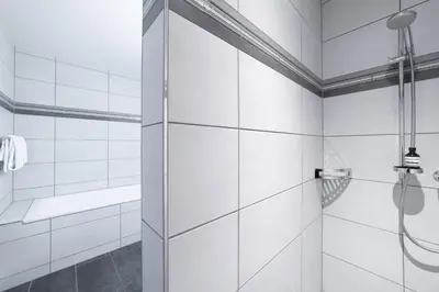 a shower with a glass door in a bathroom at Sunnewies in Wildhaus