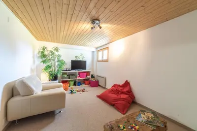a living room with a couch and a table at Steinrüti in Wildhaus