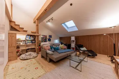 a living room with a couch and a skylight at Schwalbennest in Wildhaus