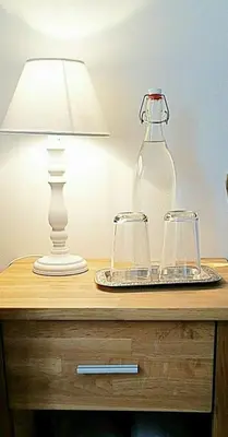 a table with two glasses and a bottle on it at Family Mountain View - Upper Alley in Buchs