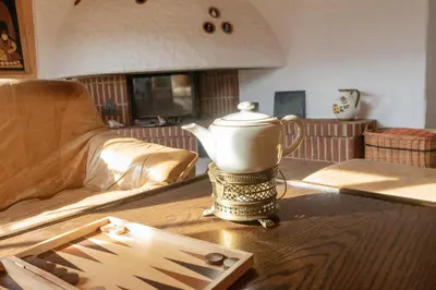 a tea kettle on a table in a living room at Tanzhaus in Wildhaus