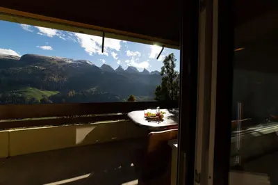a window with a table with a view of a mountain at Haldenblick in Unterwasser