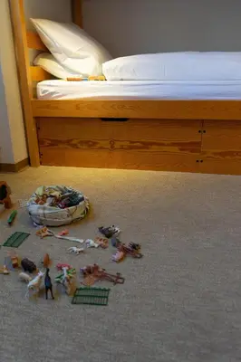 a pile of toys on the floor next to a bed at Haldenblick in Unterwasser