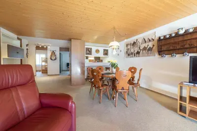 a living room and dining room with a table and chairs at Haldenblick in Unterwasser