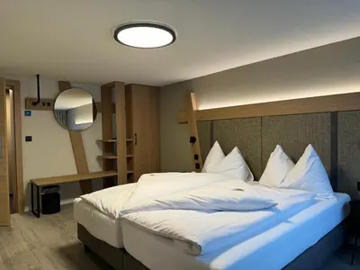 a bedroom with a large bed with white pillows at Hotel Restaurant Rössli in Alt Sankt Johann
