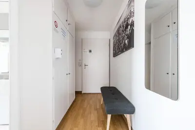 a white hallway with a bench in a room at SOHO 5B !Gratis Parken, Free Parking! in Kreuzlingen