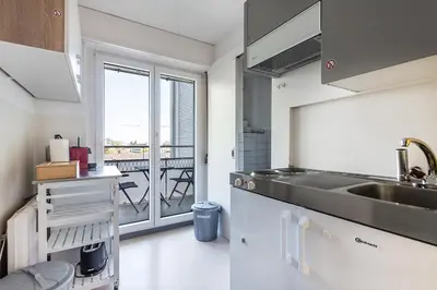 a kitchen with a sink and a view of a balcony at SOHO 5B !Gratis Parken, Free Parking! in Kreuzlingen