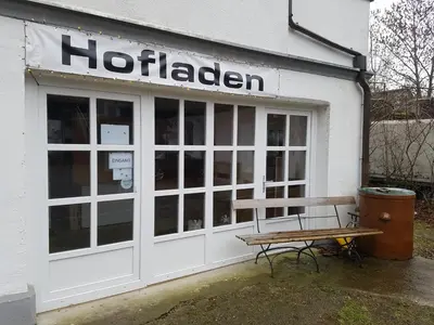a building with a bench in front of it at Bio Hof Moosburg am See mit Sauna in Güttingen