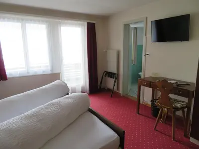 a hotel room with a bed and a desk at Landhaus an der Thur in Alt Sankt Johann