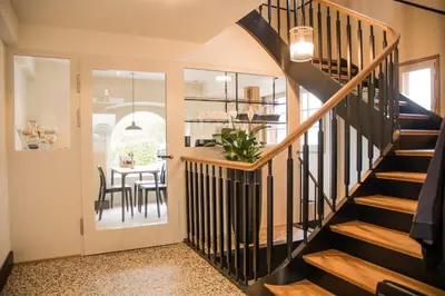 a staircase in a home with a dining room at Hotel Restaurant Falkenburg in St. Gallen