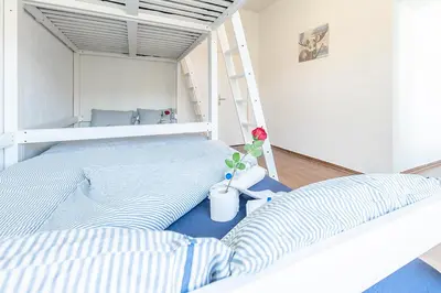 a room with two bunk beds and a bathroom at YELLOW INN - SIMPLE ROOMS -- OLMA Messen & Autobahn 1 Min, HSG 6 Min, Spital 7min, günstige Parkplätze in St. Gallen