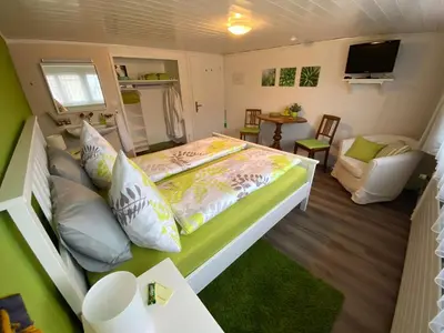 a small bedroom with a bed and a tv at Gasthaus Sternen in Degersheim